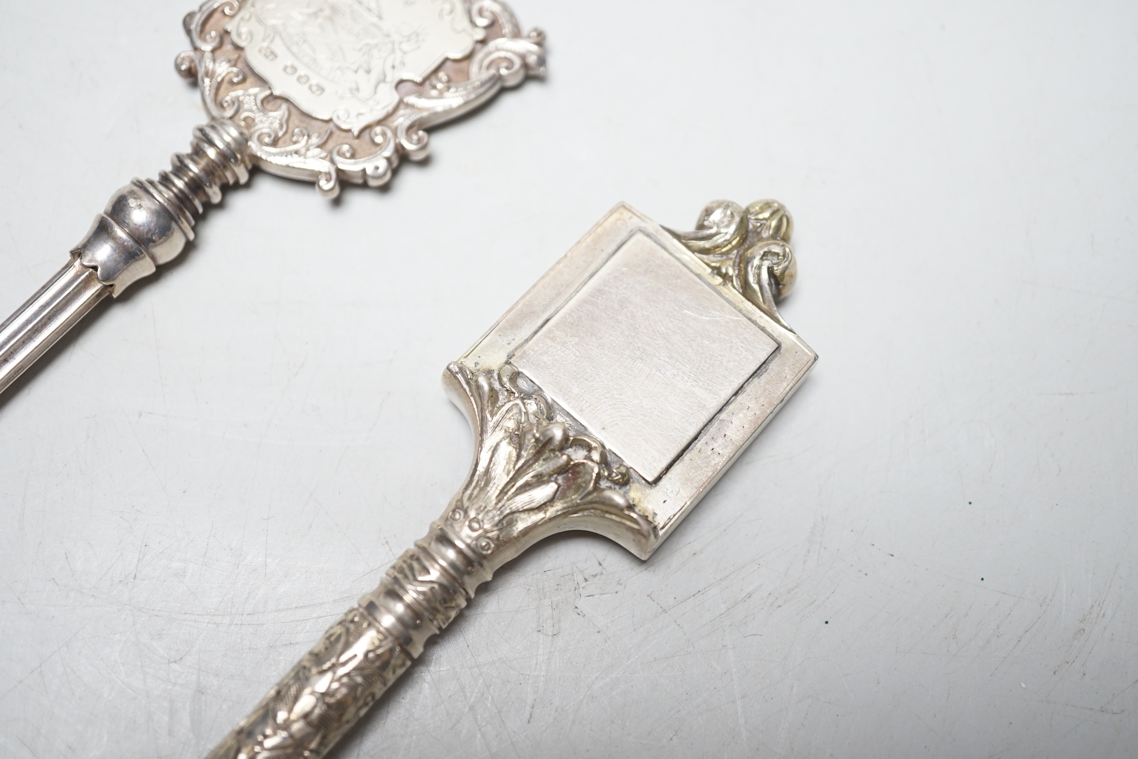 A late Victorian silver presentation key, with engraved armorial, James Fenton & Co, Birmingham, 1897, 16.9cm, 3.2oz and a similar silver plated key.